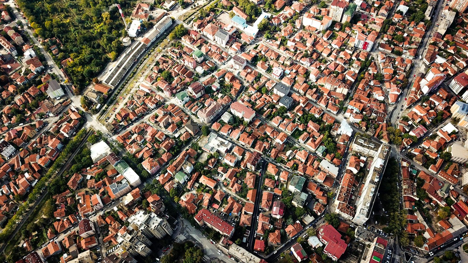 Cinematic aerial view of dense city blocks and urban landscape