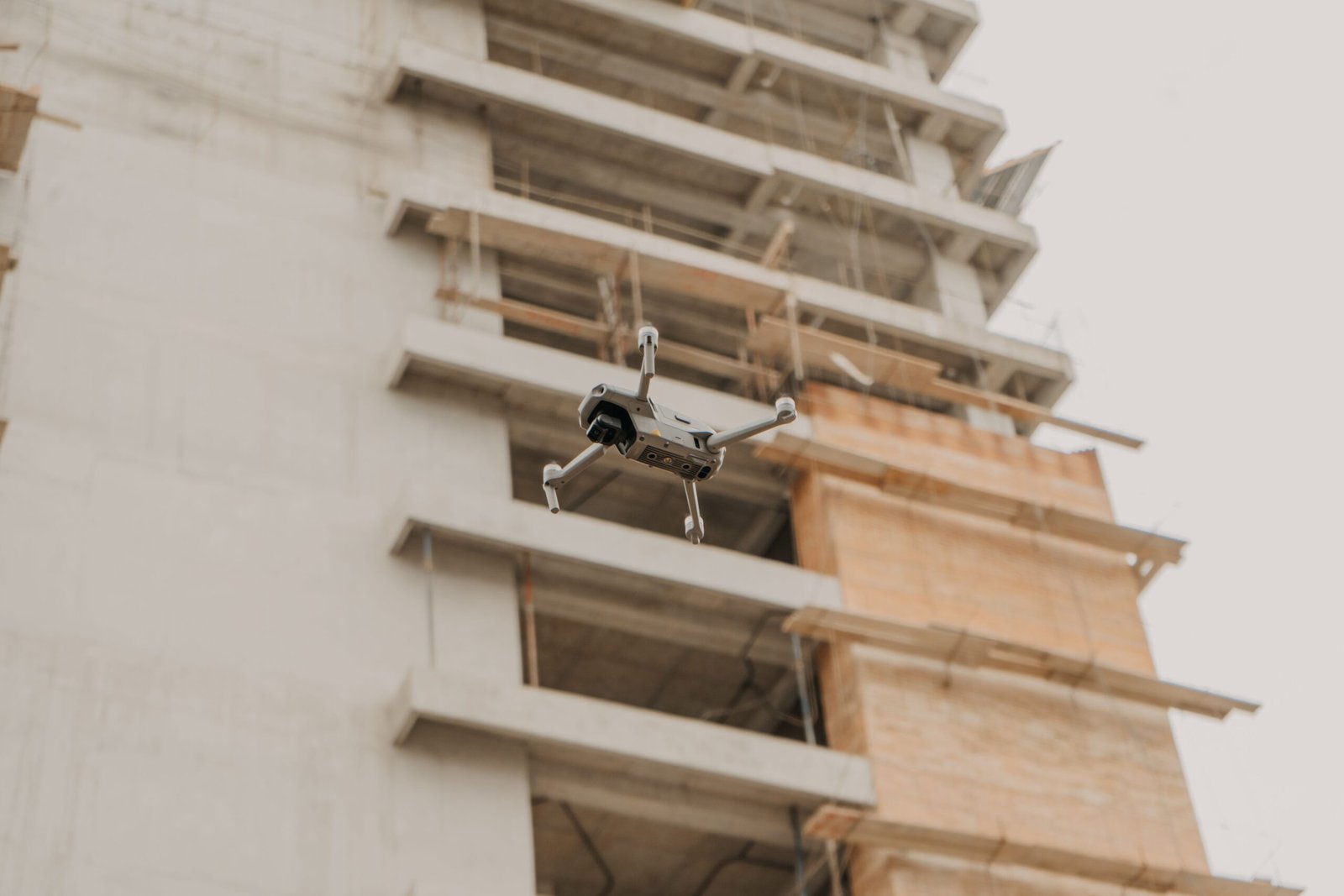 Construction progress monitoring drone capturing a commercial building project in Houston