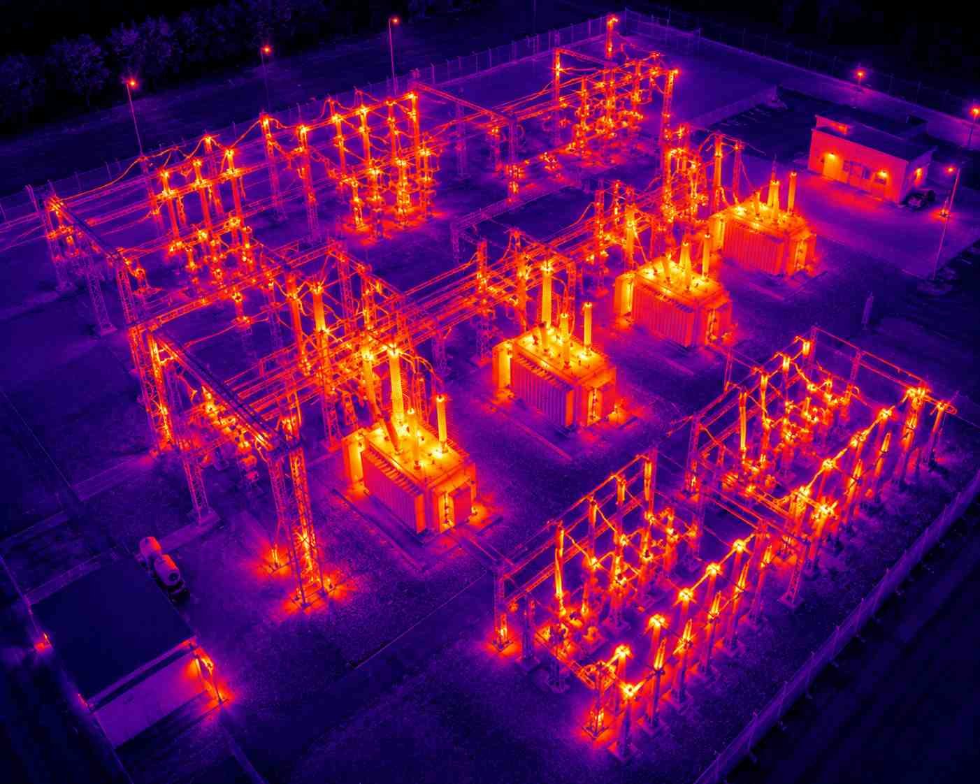 Thermal imaging services in Houston capturing heat patterns across an electrical substation at night