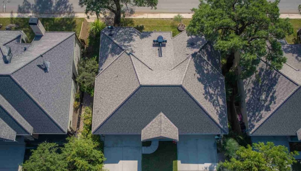 Aerial view of a Houston home with multiple gables and valleys affecting roof inspection cost