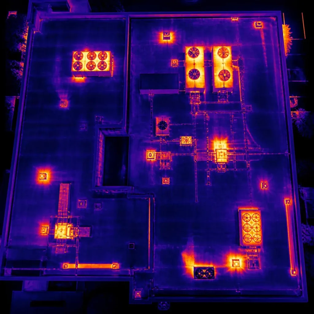 infrared roof moisture survey showing warm areas on a flat commercial roof