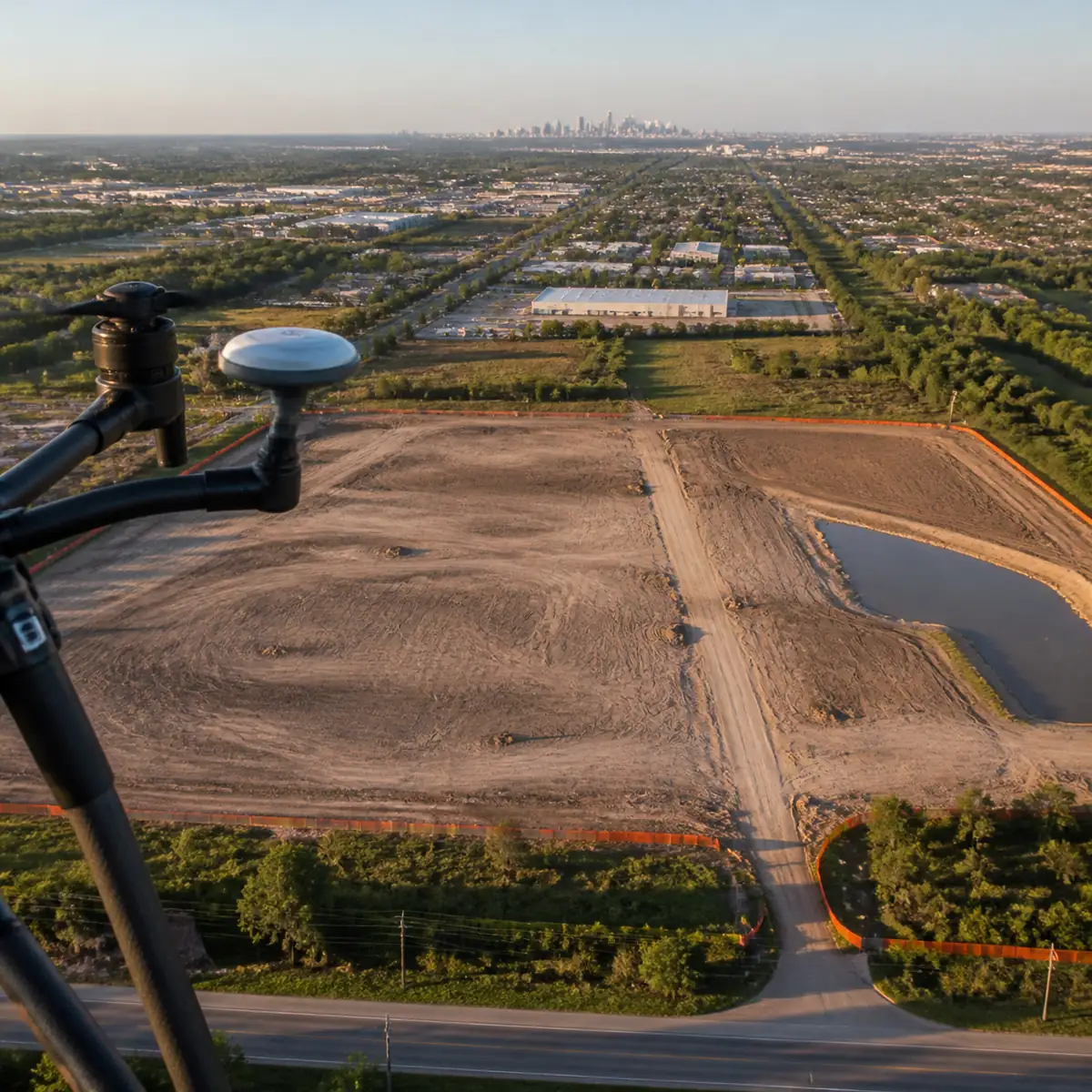 Drone survey cost in Houston shown by a quadcopter mapping a flat commercial development site